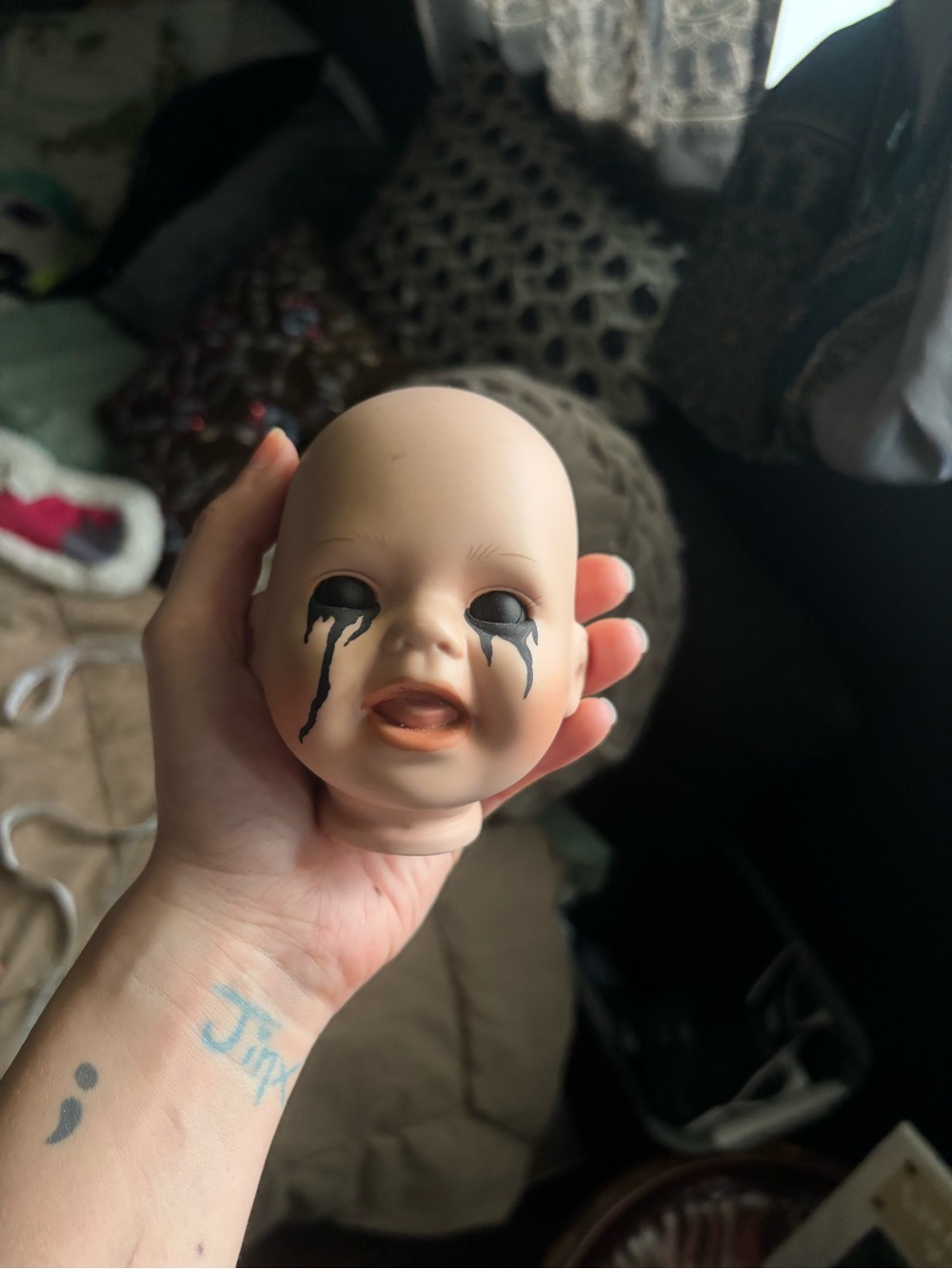 Handheld Baby Doll Head with Black Drip Eye Paint